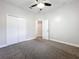 Clean, carpeted bedroom features ceiling fan and closet at 1121 Magnolia Blossom Ct, Apopka, FL 32712