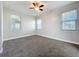 Bright bedroom featuring neutral walls, plush carpeting, and three large windows at 1121 Magnolia Blossom Ct, Apopka, FL 32712