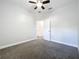 Well-lit bedroom featuring gray carpet, ceiling fan, and an entry to other rooms at 1121 Magnolia Blossom Ct, Apopka, FL 32712