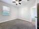 Cozy bedroom with gray carpet, a window, and a view into other rooms at 1121 Magnolia Blossom Ct, Apopka, FL 32712