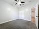 This carpeted bedroom features a ceiling fan and closet at 1121 Magnolia Blossom Ct, Apopka, FL 32712