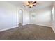 Bright bedroom featuring neutral walls, plush carpeting, and a ceiling fan with light at 1121 Magnolia Blossom Ct, Apopka, FL 32712