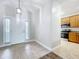 Bright foyer with tile flooring, leading to kitchen with stainless steel appliances at 1121 Magnolia Blossom Ct, Apopka, FL 32712