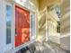 Close up of a red front door with sidelights and tiled entrance at 1121 Magnolia Blossom Ct, Apopka, FL 32712