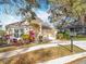 Charming single-story home with a red front door, manicured landscaping and view of mailbox at 1121 Magnolia Blossom Ct, Apopka, FL 32712