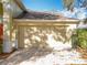 Two car garage with traditional doors and exterior lighting on a single story home at 1121 Magnolia Blossom Ct, Apopka, FL 32712