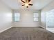 Spacious main bedroom features large windows for natural light and cozy gray carpet at 1121 Magnolia Blossom Ct, Apopka, FL 32712