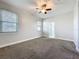 Bright, spacious main bedroom with gray carpet and an ensuite bathroom at 1121 Magnolia Blossom Ct, Apopka, FL 32712