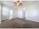 Main bedroom boasts soft gray carpet and access to other rooms, including an ensuite bathroom at 1121 Magnolia Blossom Ct, Apopka, FL 32712