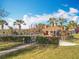 Community pavilion area with palm trees surrounded by mature trees and a metal fence at 1121 Magnolia Blossom Ct, Apopka, FL 32712