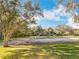 Community playground area with swings and a slide surrounded by mature trees at 1121 Magnolia Blossom Ct, Apopka, FL 32712