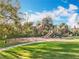 Community playground area with swings and a slide surrounded by mature trees at 1121 Magnolia Blossom Ct, Apopka, FL 32712