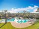 Community pool with a cabana, lounge chairs, and lush greenery creating a perfect outdoor oasis at 1121 Magnolia Blossom Ct, Apopka, FL 32712