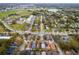 Aerial view of a residential neighborhood, showing distant lake and surrounding commercial area at 1201 City Park Ave, Orlando, FL 32808