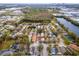 Aerial view of a residential neighborhood, showing nearby pond and distant city skyline at 1201 City Park Ave, Orlando, FL 32808