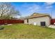 Backyard featuring a large grassy area with a red fence and the back of the home at 1201 City Park Ave, Orlando, FL 32808