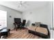 Bedroom featuring neutral-colored walls, wood floors, a desk, and a couch at 1201 City Park Ave, Orlando, FL 32808