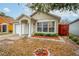 Charming single-story home with manicured front yard, white pillars, and an attached one car garage at 1201 City Park Ave, Orlando, FL 32808