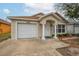 Well-kept single-story home with a one-car garage, covered entrance, and neat landscaping at 1201 City Park Ave, Orlando, FL 32808