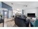 Open-concept living room with tile flooring, comfortable seating, and a view of the modern kitchen at 1201 City Park Ave, Orlando, FL 32808