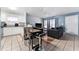 Open living space featuring a dining area, view into the living room, and granite countertops at 1201 City Park Ave, Orlando, FL 32808