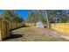 Spacious backyard featuring a new wooden fence, green grass, and a metal shed at 1322 Maryland Ave, St Cloud, FL 34769