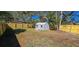 Large backyard with new wooden fence, metal storage shed and mature trees at 1322 Maryland Ave, St Cloud, FL 34769