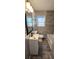 A modern bathroom featuring gray tile, a sleek vanity, and contemporary fixtures at 1322 Maryland Ave, St Cloud, FL 34769