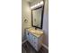 Bathroom vanity with cream sink, black hardware, granite countertop and black framed mirror at 1322 Maryland Ave, St Cloud, FL 34769