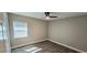 This is a bedroom with gray vinyl floors, a ceiling fan, and a window for natural light at 1322 Maryland Ave, St Cloud, FL 34769