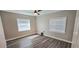 This bedroom features gray vinyl floors, natural lighting, and a ceiling fan at 1322 Maryland Ave, St Cloud, FL 34769