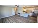 Modern living room with wood flooring and a fireplace adjoins the kitchen, creating an open and inviting space at 1322 Maryland Ave, St Cloud, FL 34769