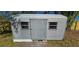 Exterior view of metal corrugated storage shed in backyard with windows and door at 1322 Maryland Ave, St Cloud, FL 34769