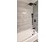 This shower showcases gray tiles, a rainfall showerhead, and modern fixtures at 1322 Maryland Ave, St Cloud, FL 34769