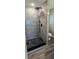 This standup shower has gray tiles and black accents to give a modern feel at 1322 Maryland Ave, St Cloud, FL 34769