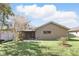 Beautiful backyard with green space and a glimpse of the home's exterior at 1412 Borg Ln, Winter Springs, FL 32708