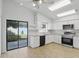 Contemporary kitchen featuring stainless steel appliances, white cabinets, and granite countertops at 1412 Borg Ln, Winter Springs, FL 32708