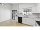 Bright kitchen with white cabinets, granite countertops, and a stainless steel sink at 1412 Borg Ln, Winter Springs, FL 32708