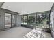 Enclosed screened porch with ceiling, view of the green backyard, and access to interior at 1412 Borg Ln, Winter Springs, FL 32708