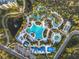 Aerial view of a waterpark featuring multiple pools, slides, cabanas, and lush landscape at 14501 Grove Resort Grove Resort Ave # 3733, Winter Garden, FL 34787