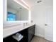 Bathroom featuring one sink, modern vanity, large mirror, and door at 14501 Grove Resort Grove Resort Ave # 3733, Winter Garden, FL 34787
