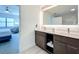 Bathroom featuring dual sinks, modern vanity, large mirror, and view of bedroom at 14501 Grove Resort Grove Resort Ave # 3733, Winter Garden, FL 34787