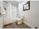 Clean bathroom features a shower-tub combination with white subway tiles and gray wood-look floors at 14501 Grove Resort Grove Resort Ave # 3733, Winter Garden, FL 34787