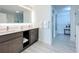Bathroom featuring dual sinks, modern vanity, large mirror, and walk-in closet at 14501 Grove Resort Grove Resort Ave # 3733, Winter Garden, FL 34787
