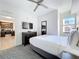 Bedroom with king bed, ceiling fan, dresser, and kitchen view at 14501 Grove Resort Grove Resort Ave # 3733, Winter Garden, FL 34787
