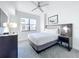 Bedroom with king bed, ceiling fan, carpet, and ample natural light at 14501 Grove Resort Grove Resort Ave # 3733, Winter Garden, FL 34787