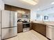 Modern kitchen features stainless steel appliances, sleek cabinetry, and a well-lit countertop, offering a stylish culinary space at 14501 Grove Resort Grove Resort Ave # 3733, Winter Garden, FL 34787
