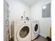 Neat laundry room featuring a Whirlpool washer and dryer, plus utility connections and gray water heater at 14501 Grove Resort Grove Resort Ave # 3733, Winter Garden, FL 34787