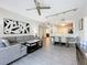 Open-concept living room with gray sofa, ceiling fan, dining area, and modern art at 14501 Grove Resort Grove Resort Ave # 3733, Winter Garden, FL 34787