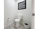 Clean powder room featuring white toilet and a modern black and white art at 14501 Grove Resort Grove Resort Ave # 3733, Winter Garden, FL 34787